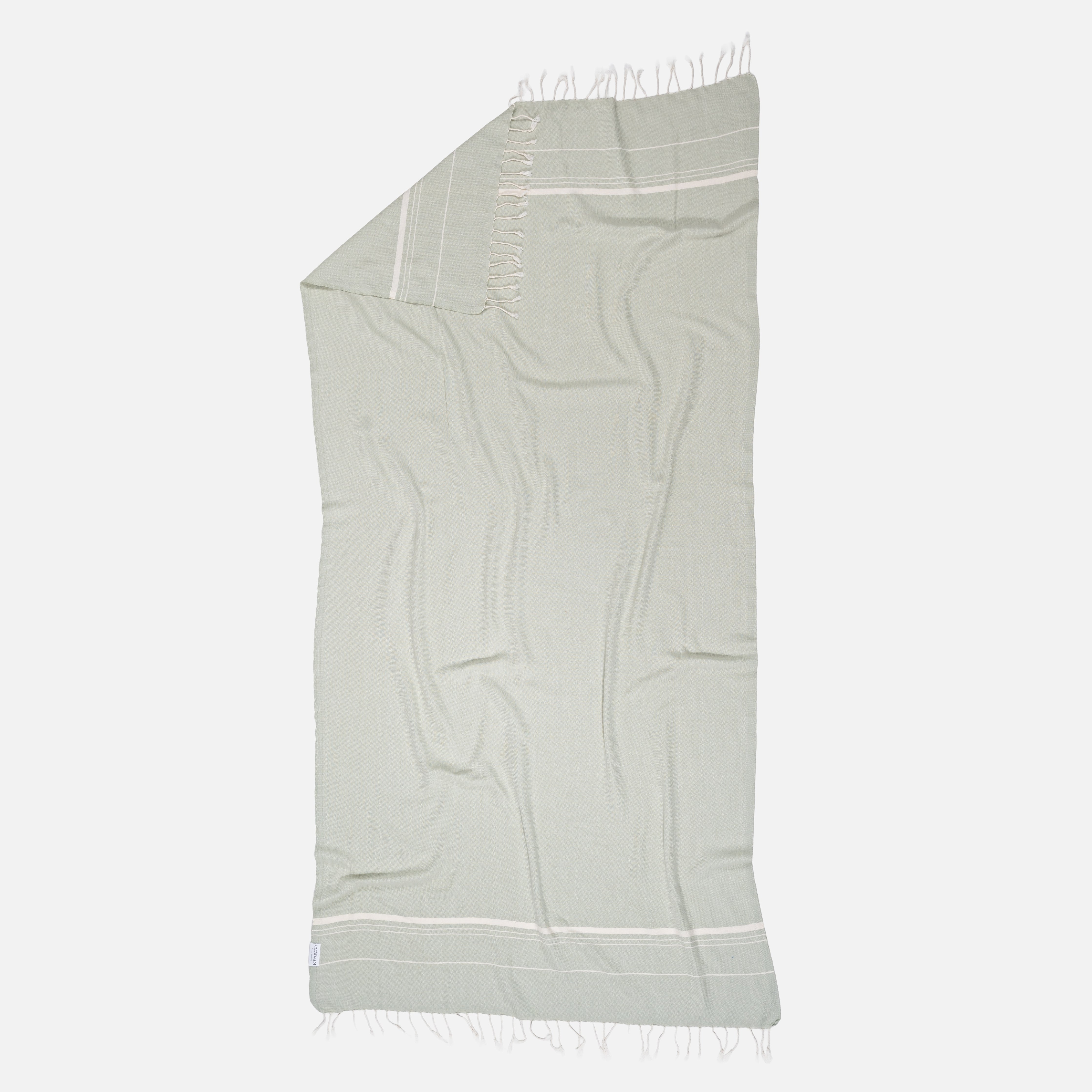 Nahaufnahme der feinen Dobby Webung des Ecobain Premiumtuchs 'Bathroom Air' im harmonischen Naturton Magic Mermaid. Das Bild verdeutlicht die smarte Textur, die dieses ultraleichte Tuch zu einem kompromisslos saugstarken Begleiter macht. Ein ehrliches Design Statement für Menschen, die ein nachhaltiges, besseres Microfasertuch suchen und bei Frische sowie garantierter Plastikfreiheit keine Abstriche machen wollen.