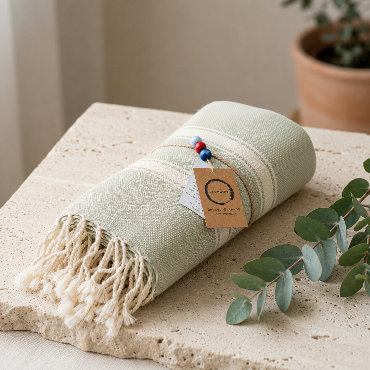 Ein minimalistisch drapiertes Ecobain Hamamtuch der 'New Classic' Serie auf einem modernen Stein-Tablett. Das Tuch besticht durch seine ultraleichte, hochsaugfähige Webart aus hochwertiger, gekämmter Baumwolle – die smarte und platzsparende Saunalösung. Als plastikfreie, schnelltrocknende Alternative zu schwerem Frottee vereint es maximale Funktionalität mit ästhetischem Design für exklusive Wellness-Momente.